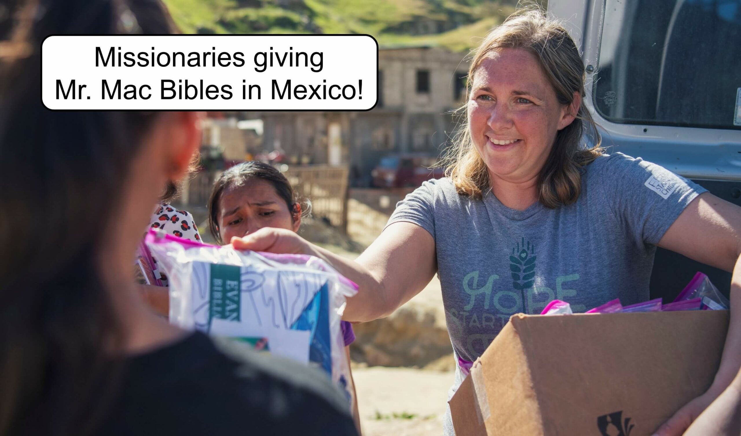 Missionaries giving Mr. Mac Bibles!